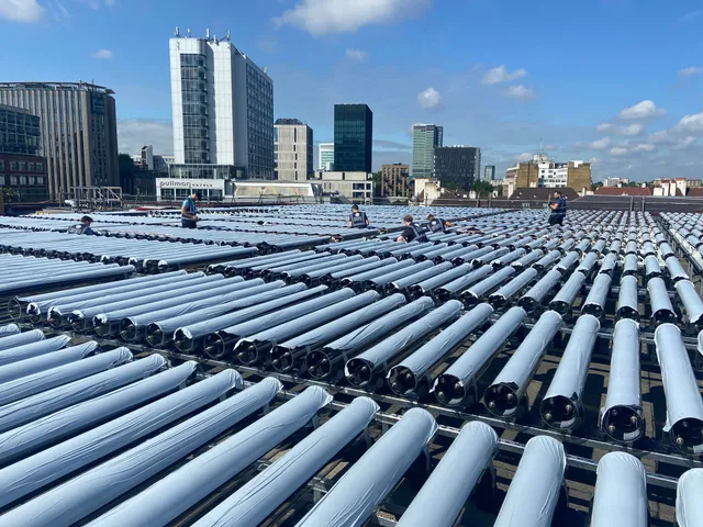 Convert Energy engineers installing evacuated-tube PV-T collectors on a London rooftop